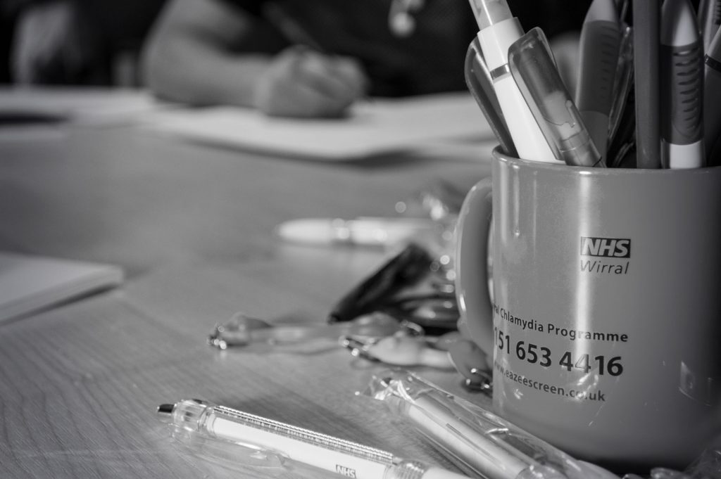 An image showing a mug filled with pens in focus representing the theme of ways to stay creative