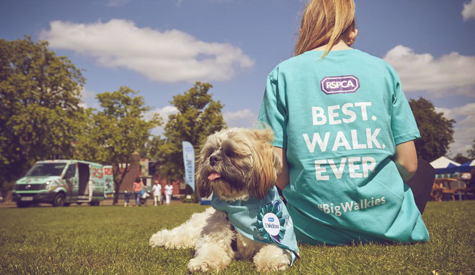 Girl wearing t-shirt with dog behind her