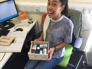 An image of Shanice from Bluestep holding a box of gin