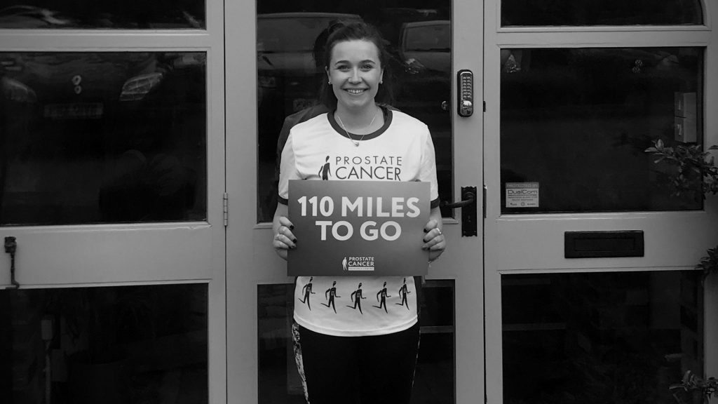 Becca Holding 110 miles sign